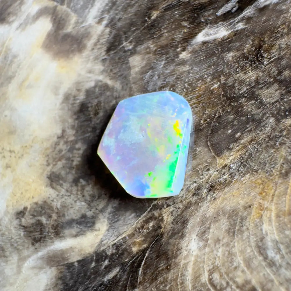 Irregularly shaped opal with iridescent colors.