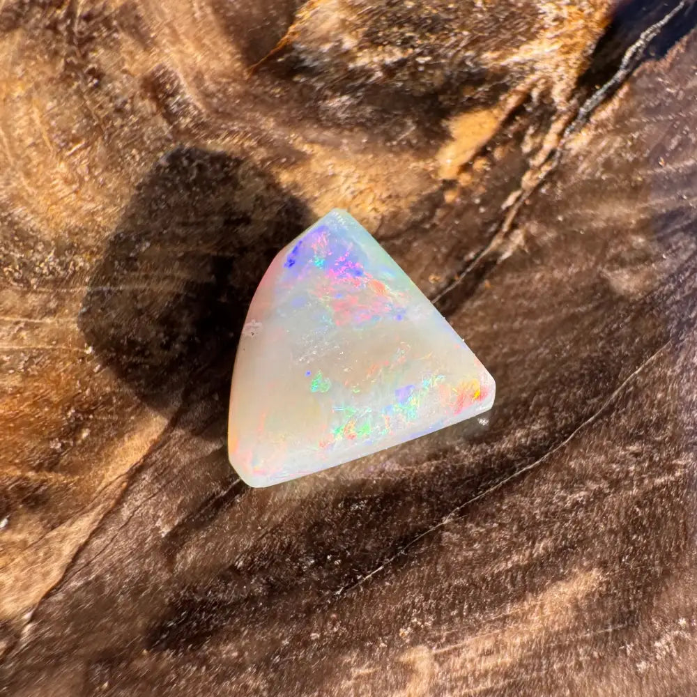 Iridescent triangular Lightning Ridge semi black opal in the 1.0 carat hand-cut solid gemstone