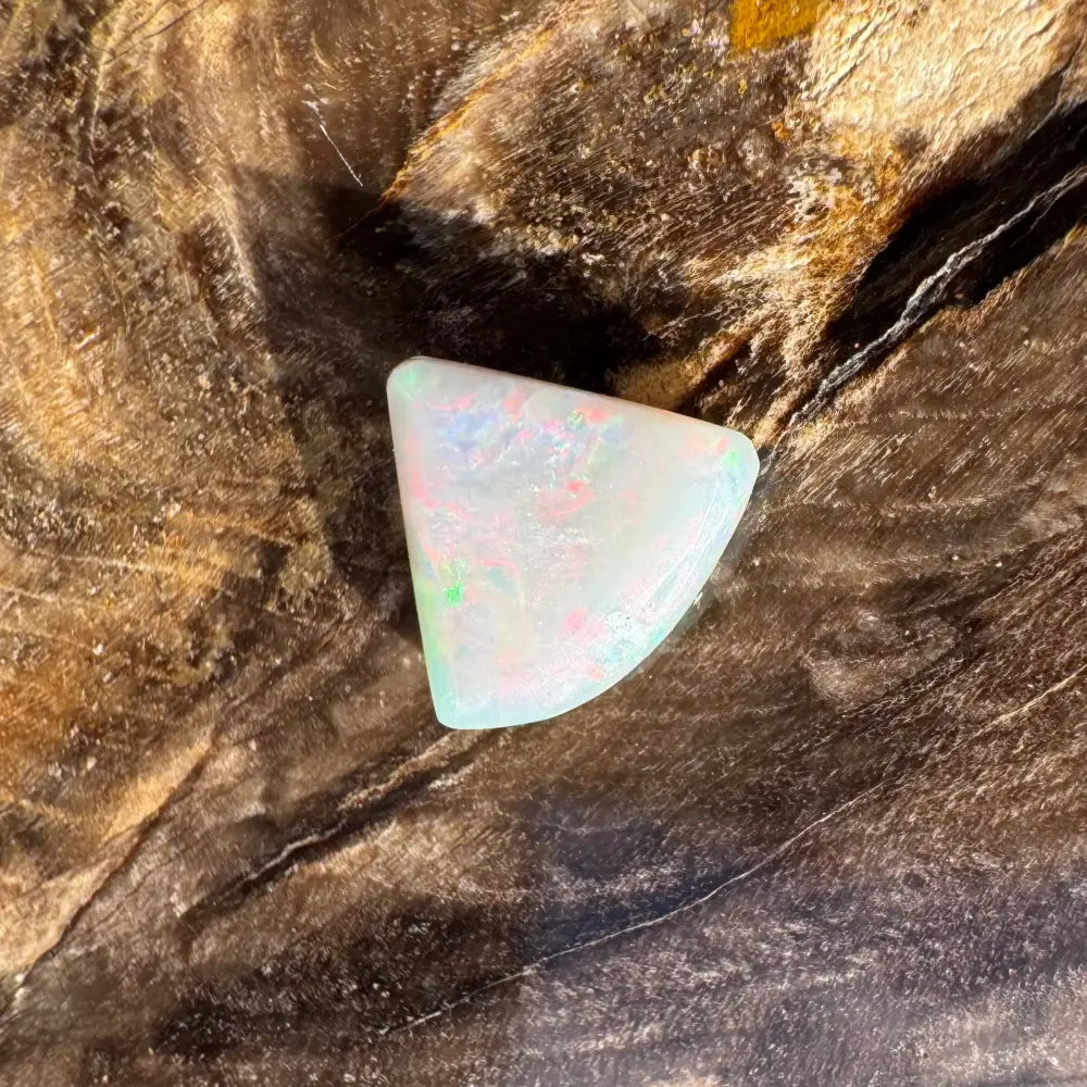 Iridescent triangular opal cabochon from Lightning Ridge in a 1.0 carat hand-cut setting