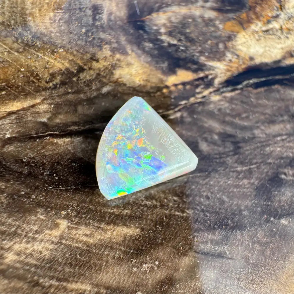 Iridescent triangular Opal gemstone displayed in 1.0 carat Hand-Cut Solid Lightning Ridge Semi Black Opal