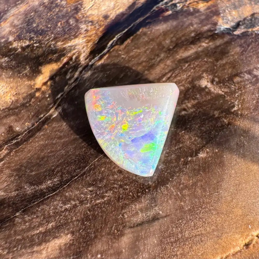 Iridescent triangular opal from Lightning Ridge in the 1.0 carat hand-cut solid semi-black opal jewelry