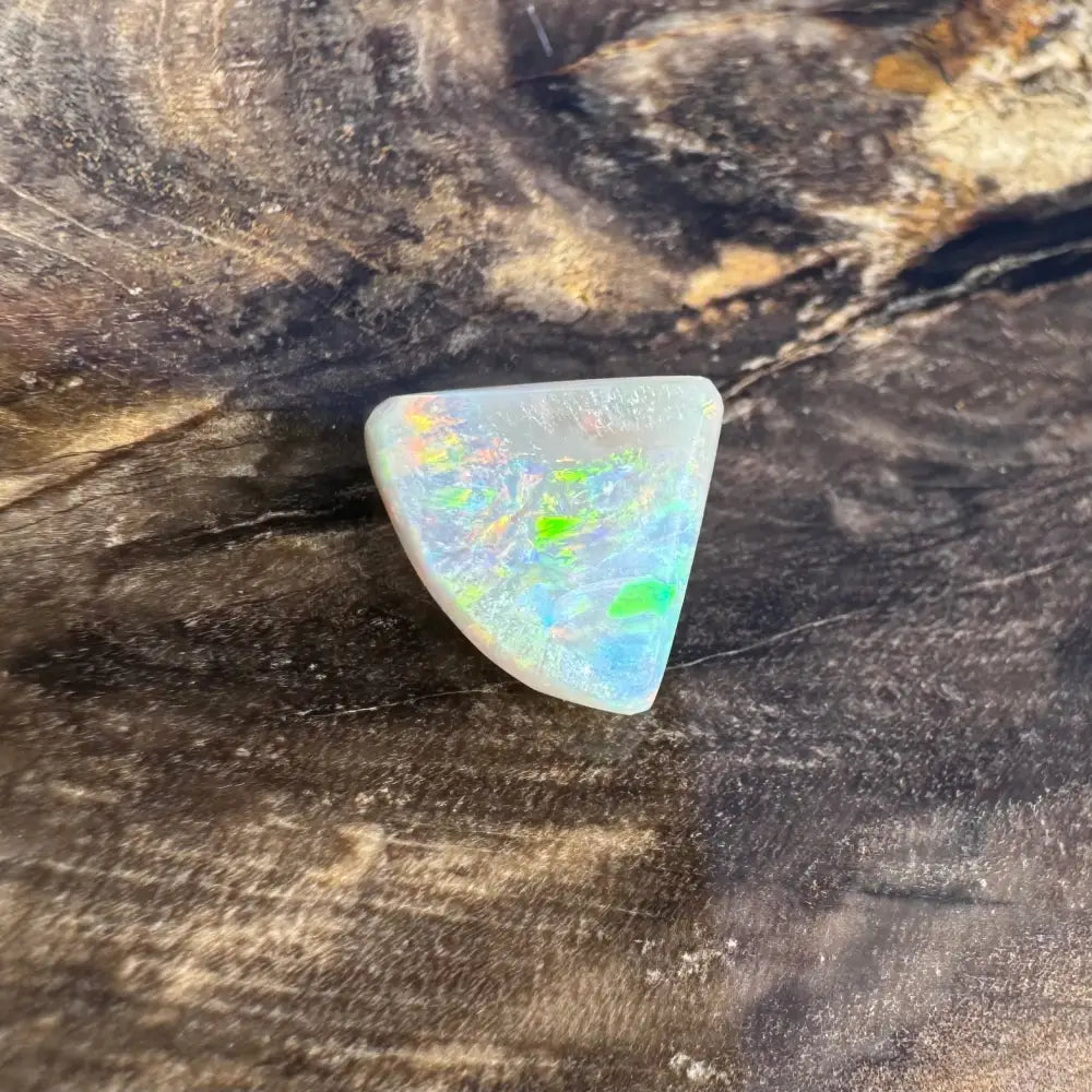 Iridescent triangular opal cabochon from Lightning Ridge in 1.0 carat hand-cut solid black opal product