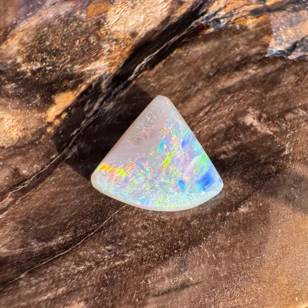 Triangular opal gemstone with iridescent colors from Lightning Ridge in the 1.0carat Hand-Cut Semi Black Opal product