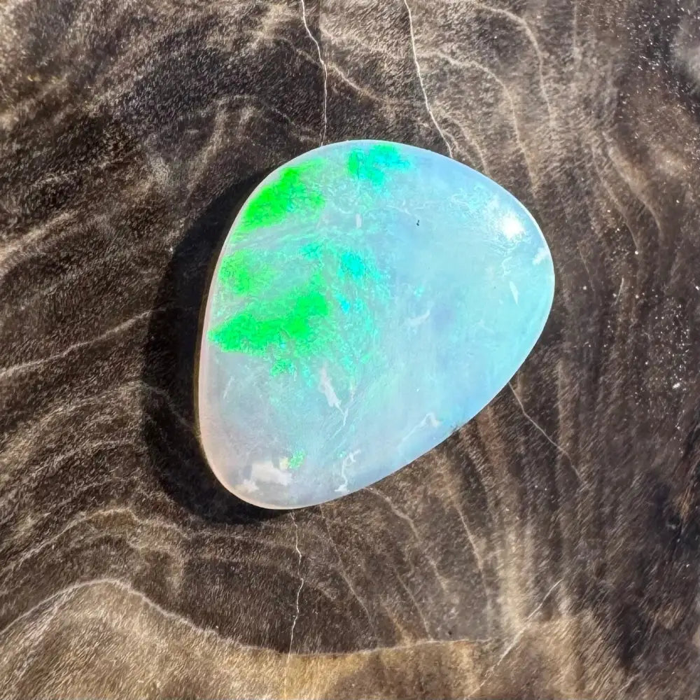 Iridescent opal gemstone with green flashes.
