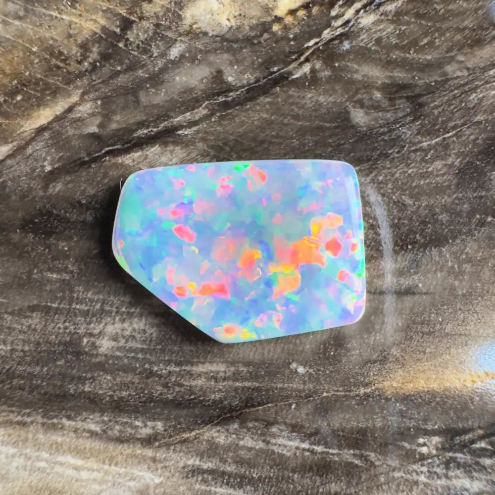 Irregularly shaped opal with vibrant, multicolored flashes.