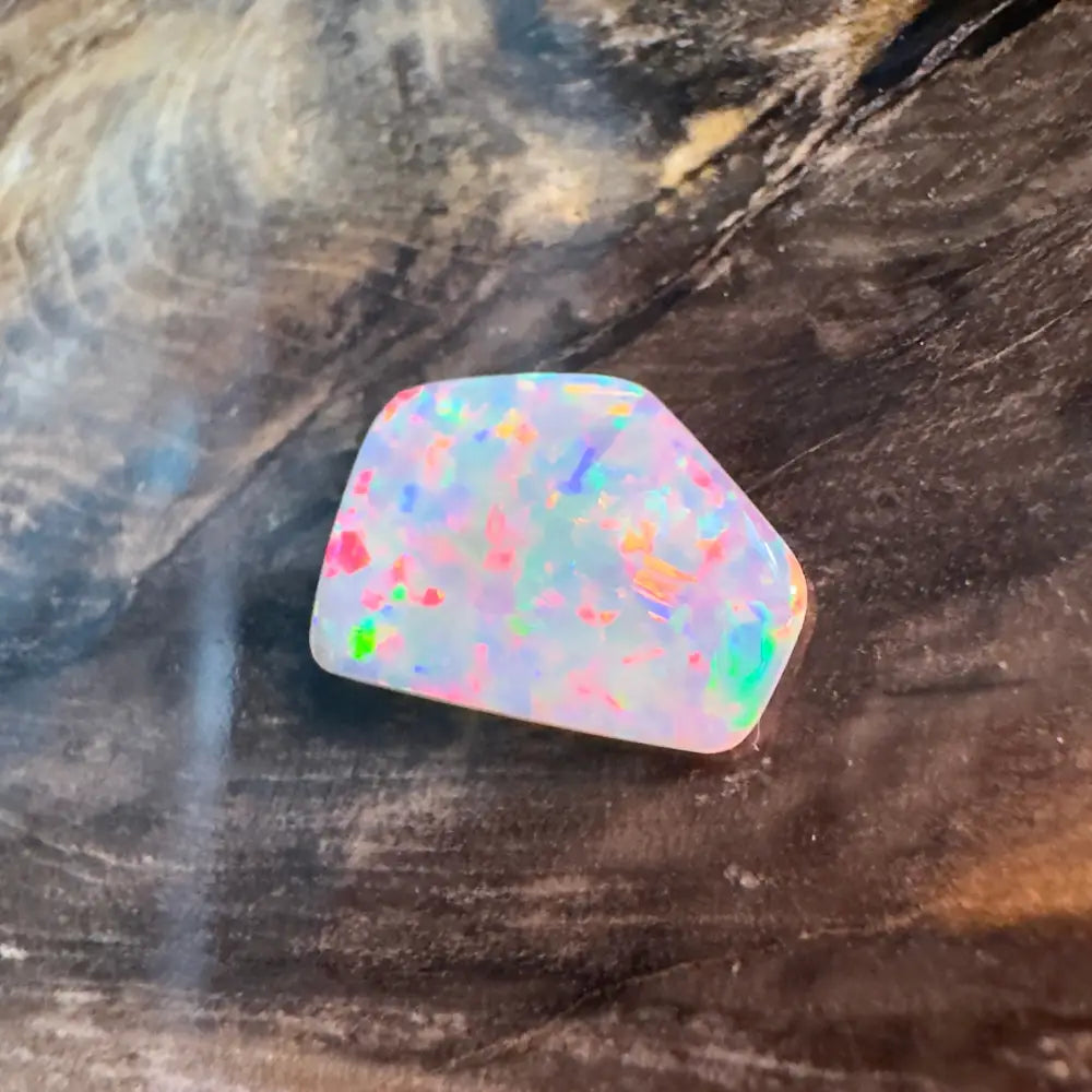 Irregularly shaped opal with multicolored flashes.