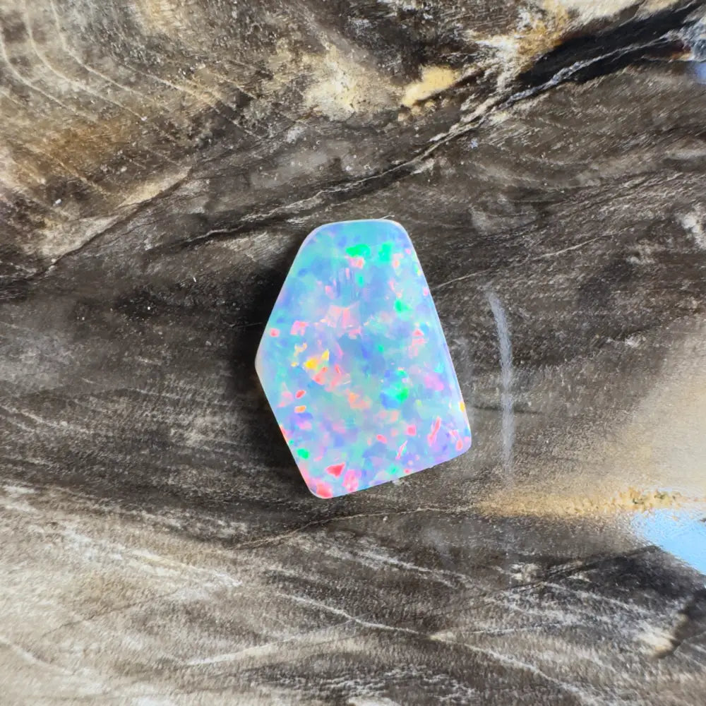 Irregularly shaped opal with multicolored flashes.