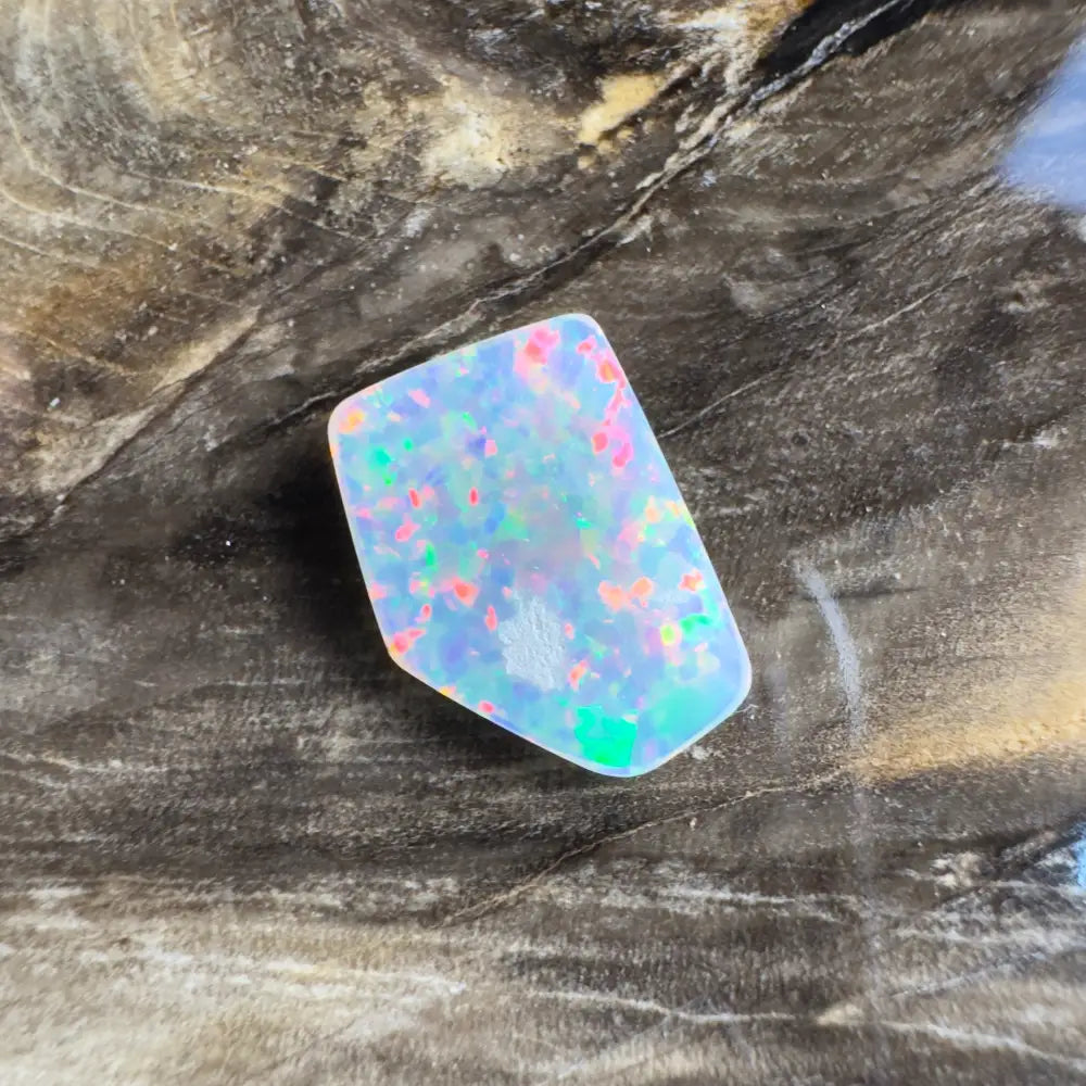 Irregularly shaped opal with multicolored flashes.