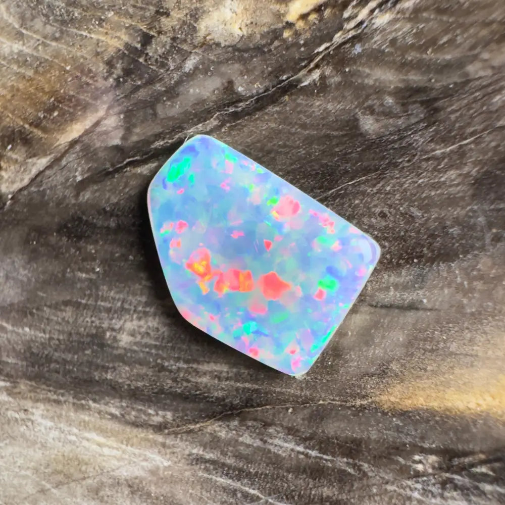 Irregularly shaped opal with colorful flashes.