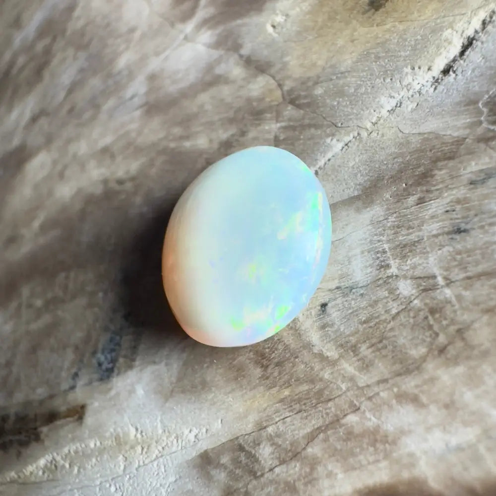 Oval opal gemstone with iridescent play-of-color.