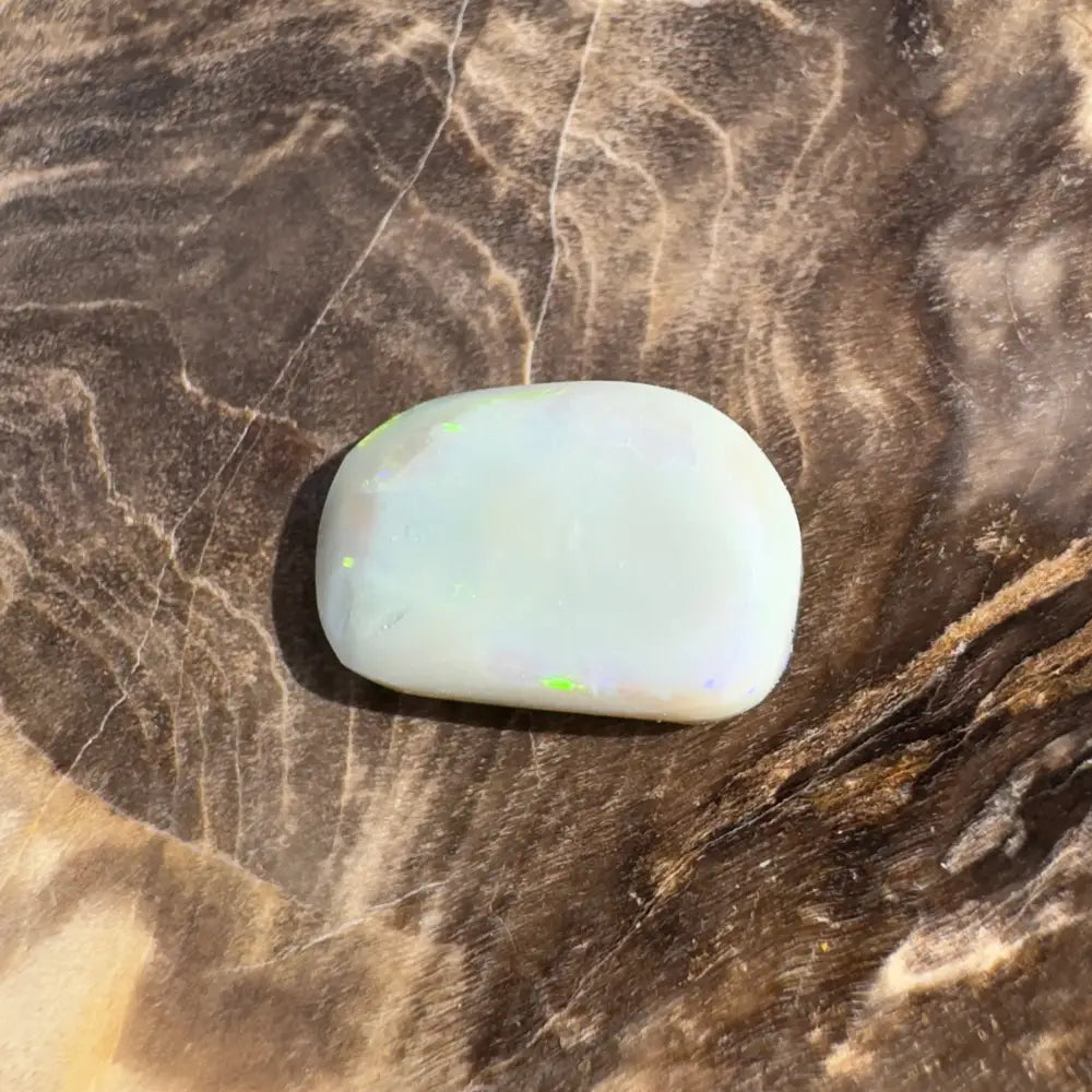 Iridescent, rounded opal cabochon.