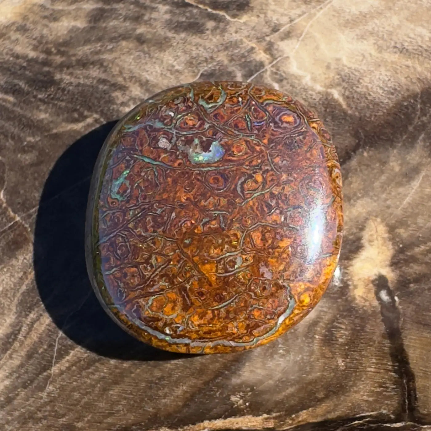 Polished Boulder Opal cabochon from the 12.2ct Hand-Cut Solid Boulder Opal gemstone collection