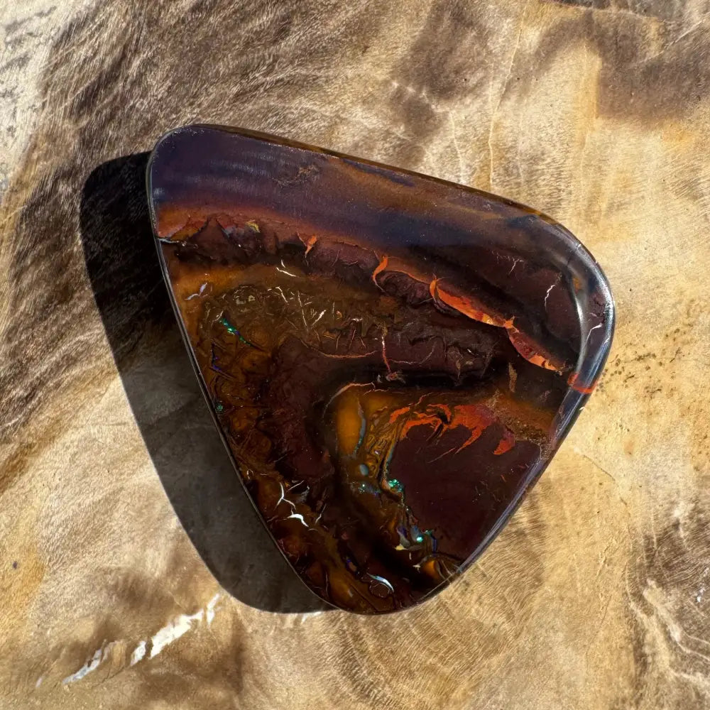 Polished dark opal gemstone.
