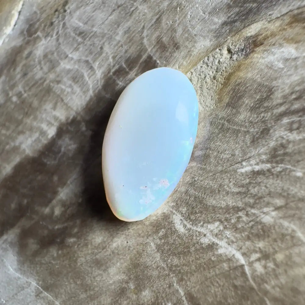 Iridescent, oval opal cabochon.