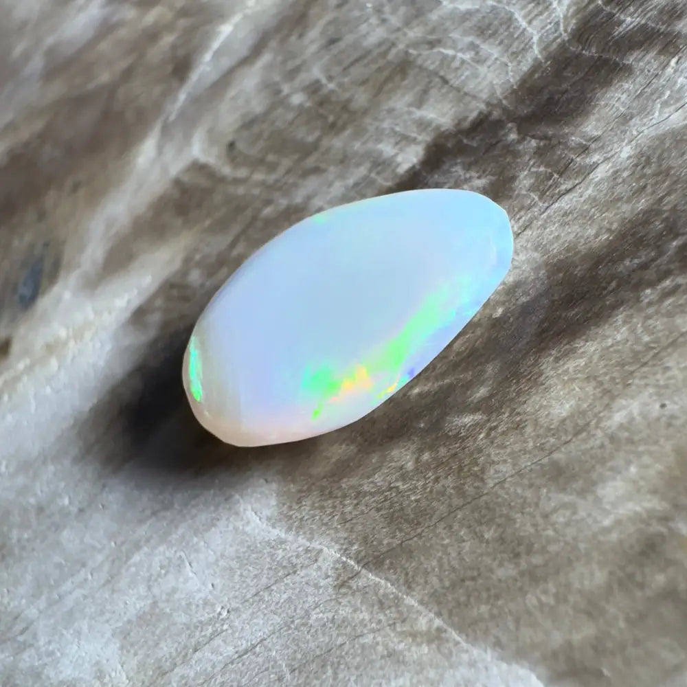 Iridescent, polished opal cabochon.