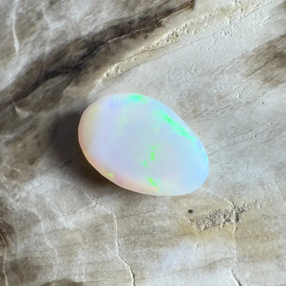 Iridescent white opal cabochon.