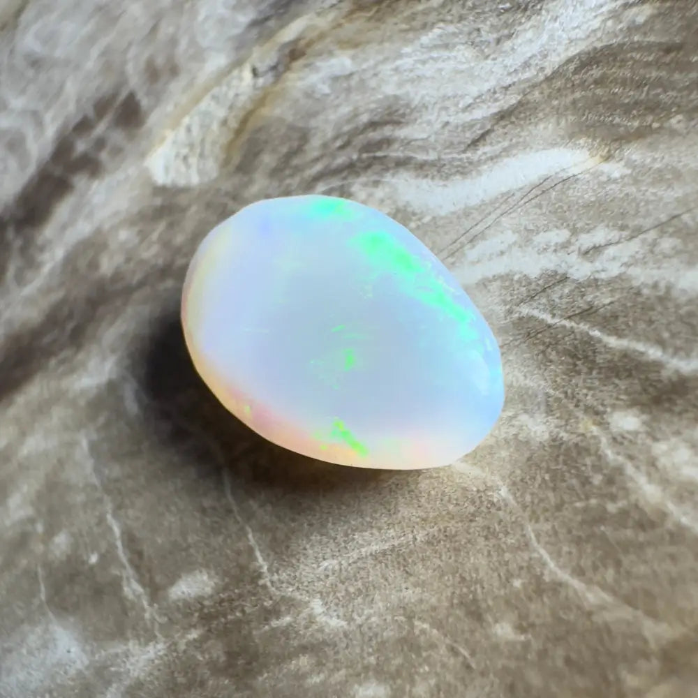 Iridescent white opal cabochon.