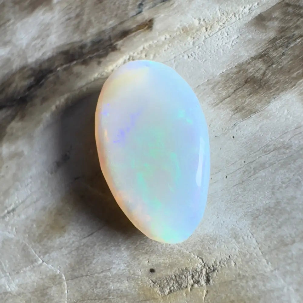 Iridescent white opal cabochon.