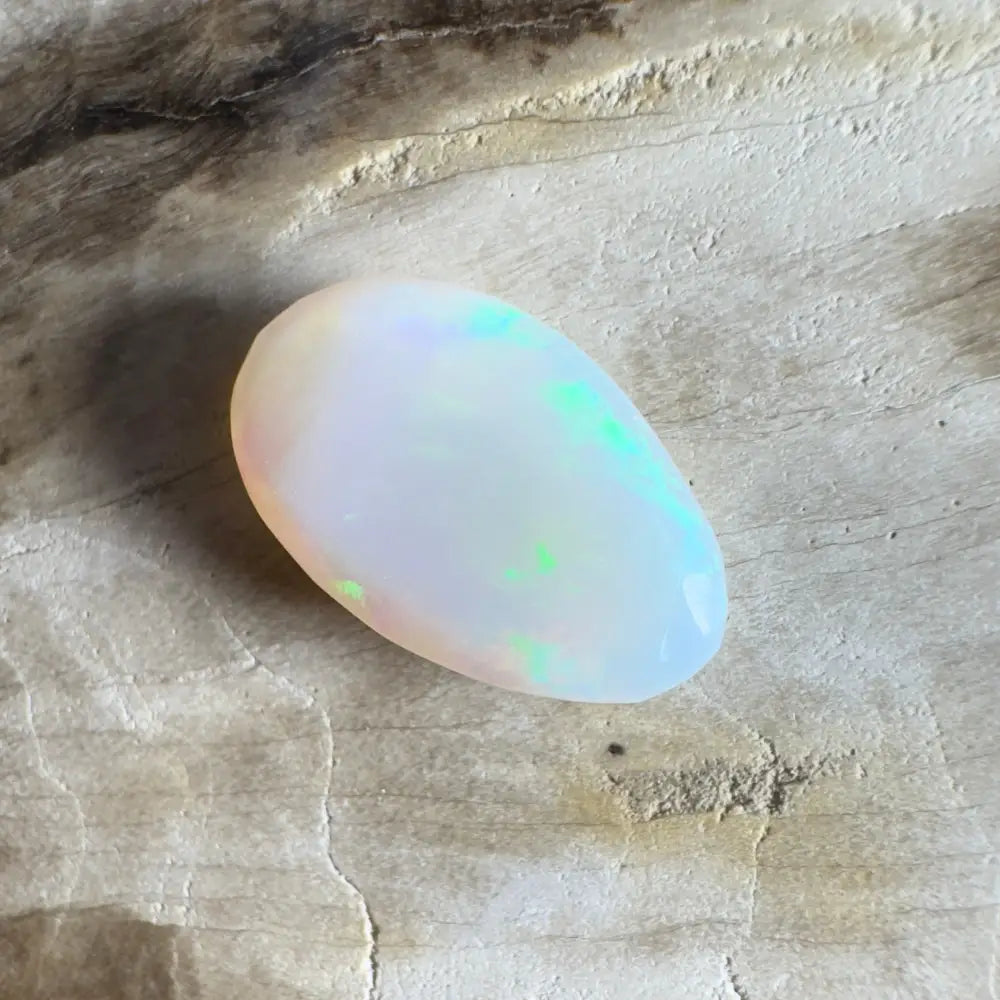 Iridescent white opal cabochon.