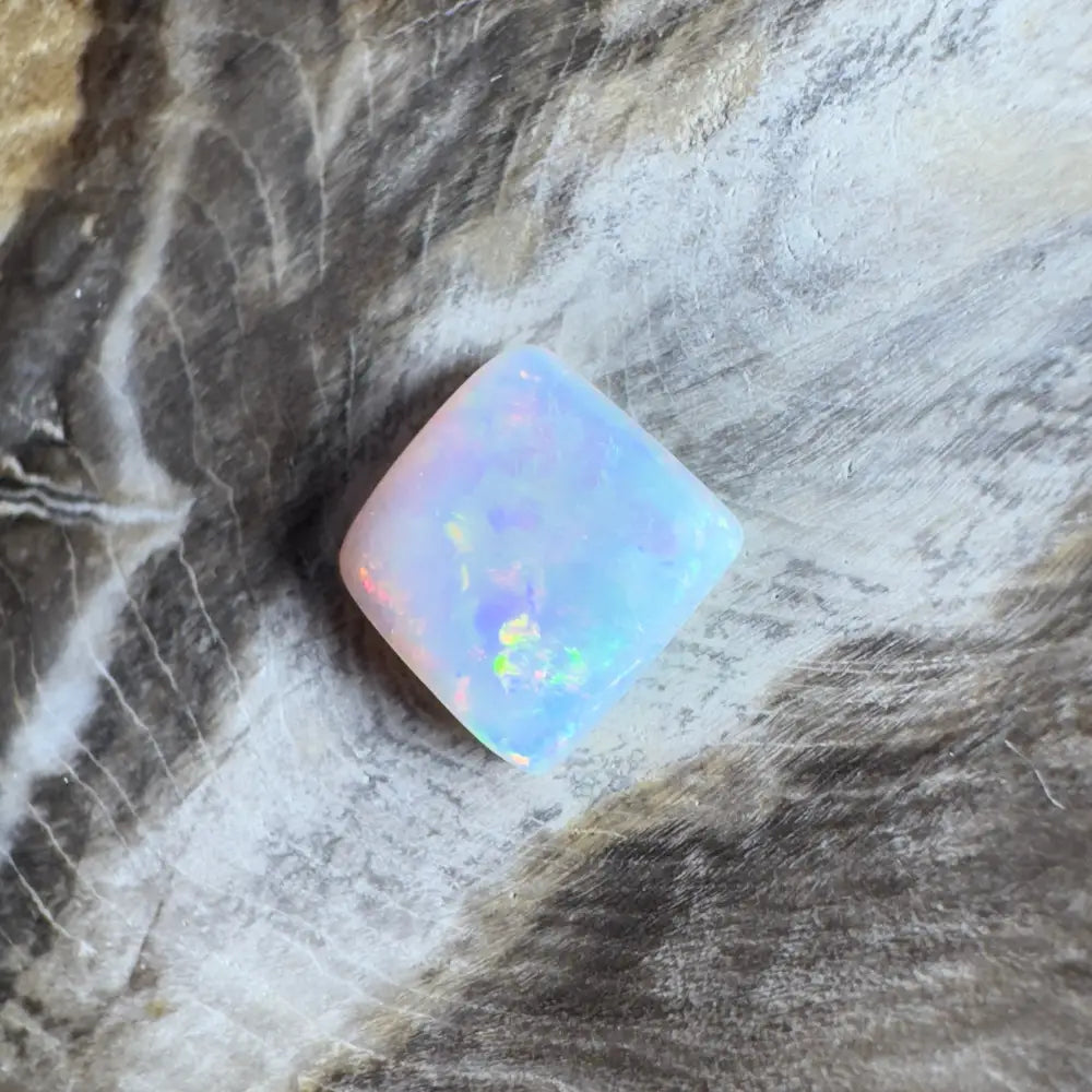 Iridescent, cushion-cut opal.