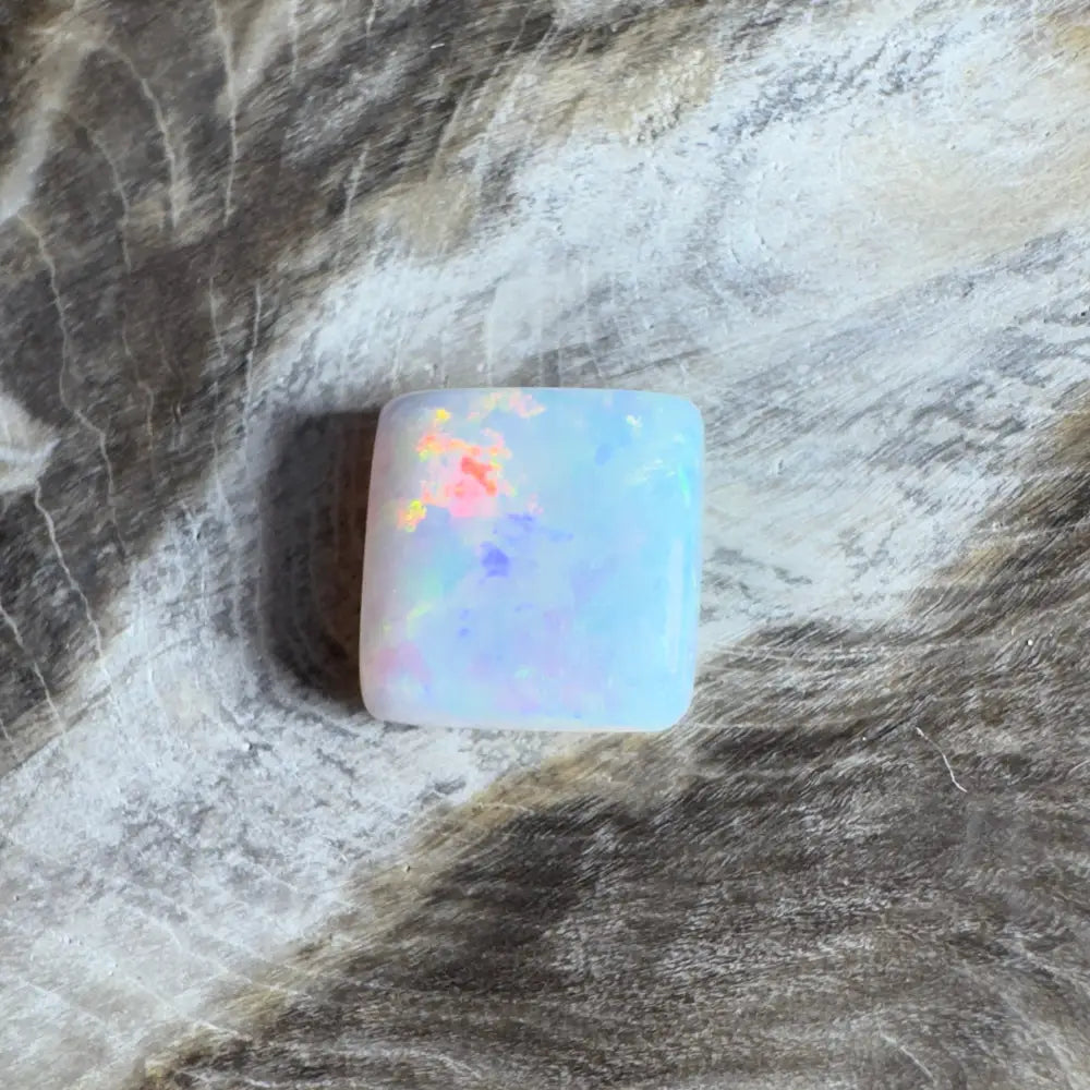 Iridescent, square opal cabochon.
