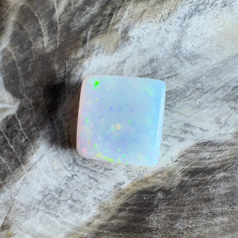 Square opal cabochon with iridescent play-of-color.