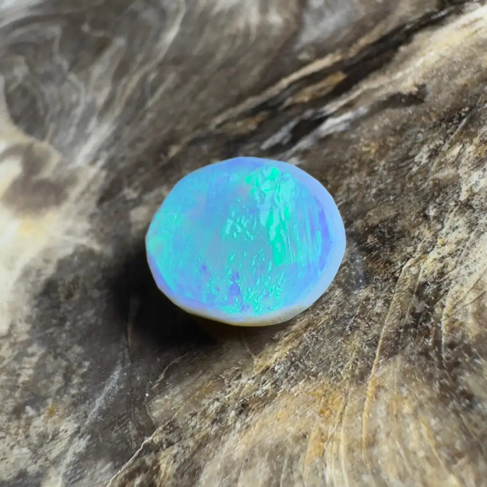 Iridescent blue-green opal cabochon.