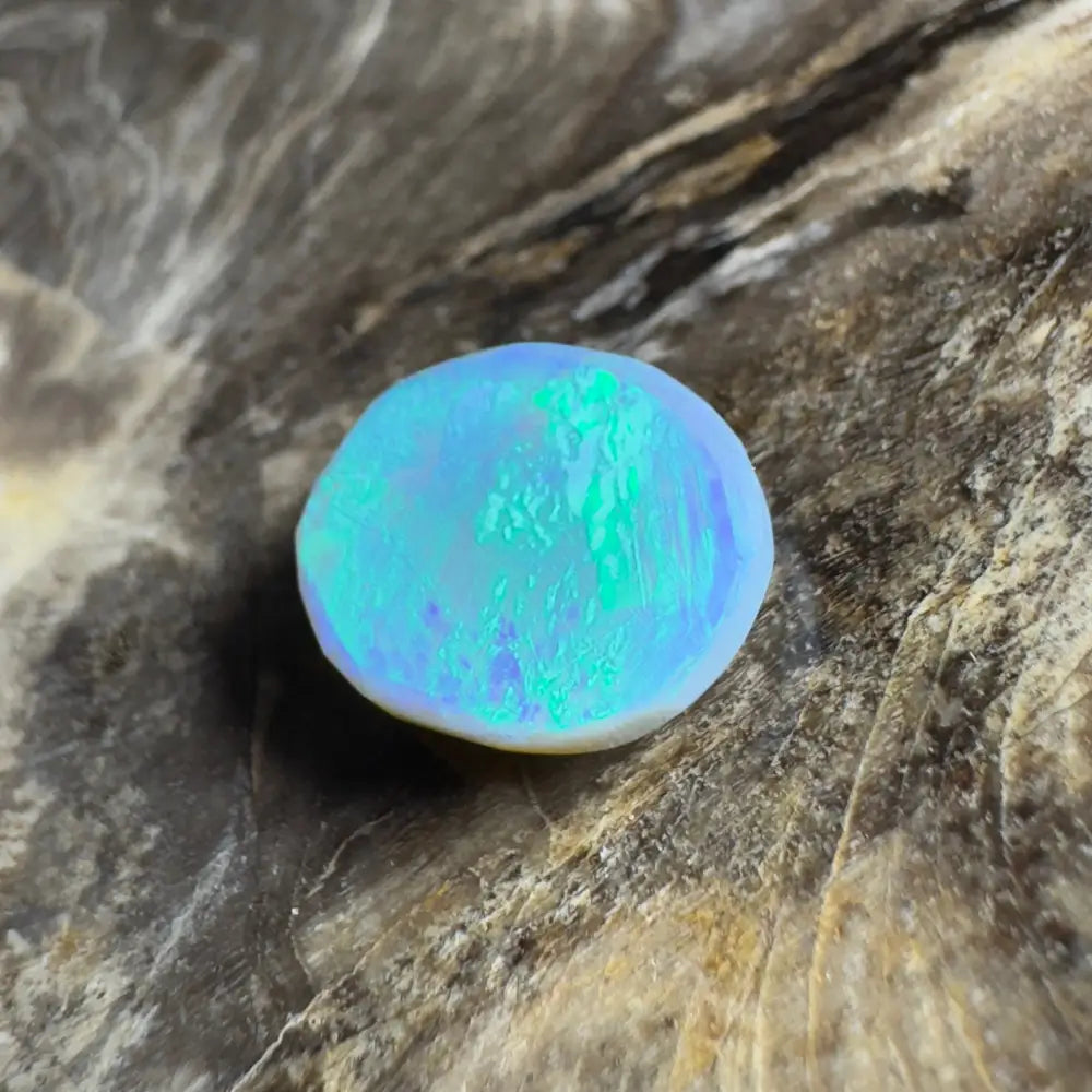 Iridescent blue-green opal cabochon.