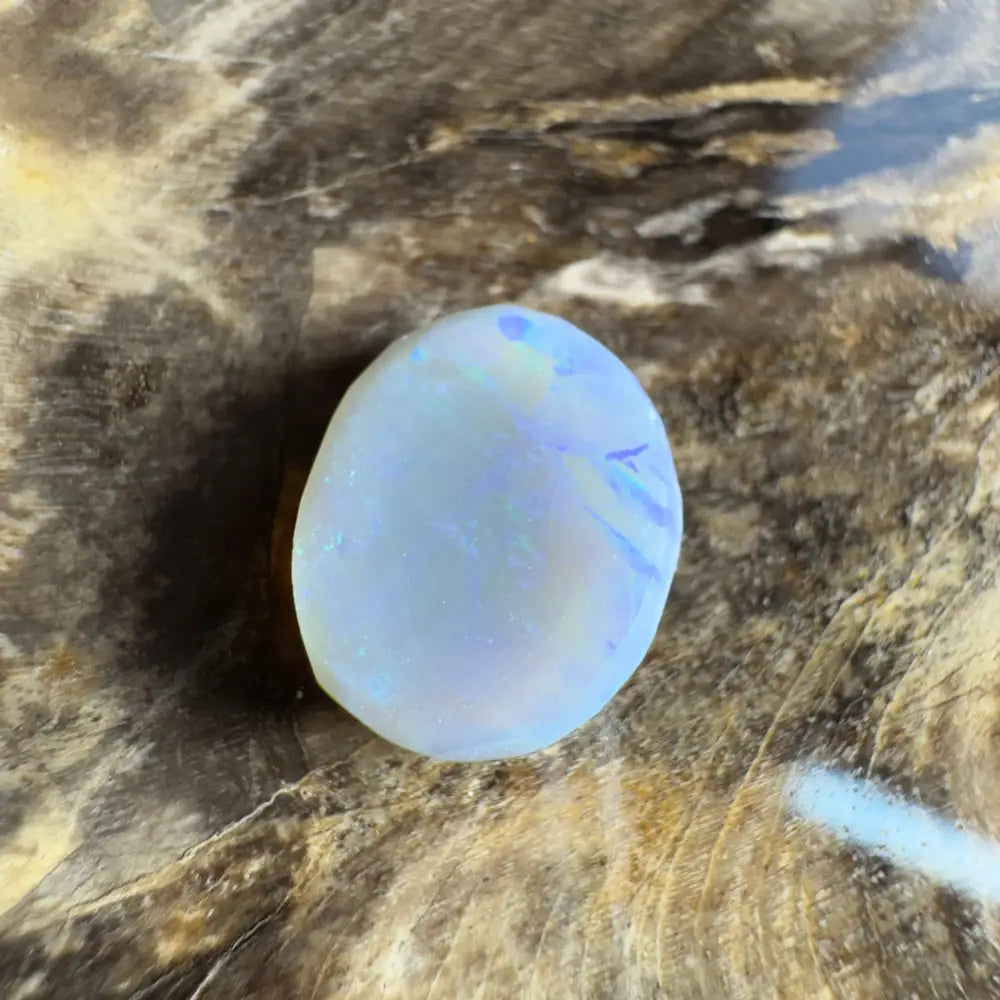 Iridescent, oval opal cabochon.