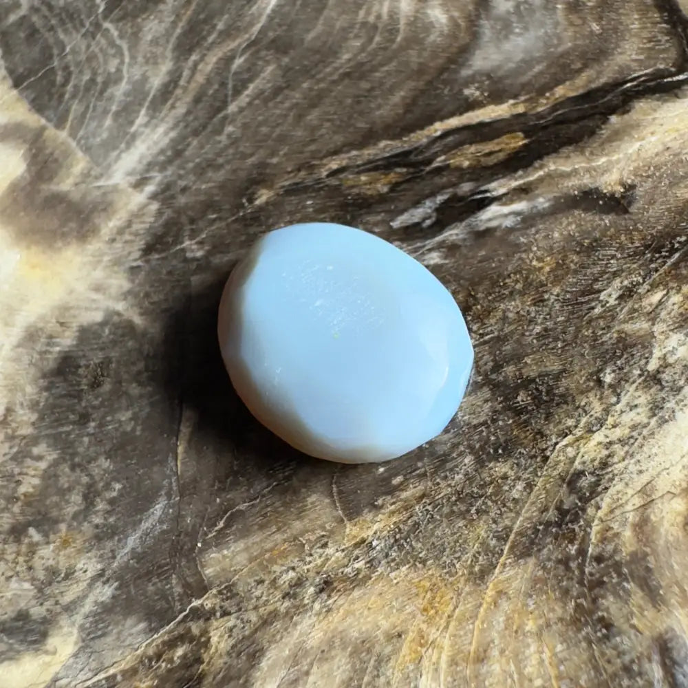 Smooth, light blue opal cabochon.