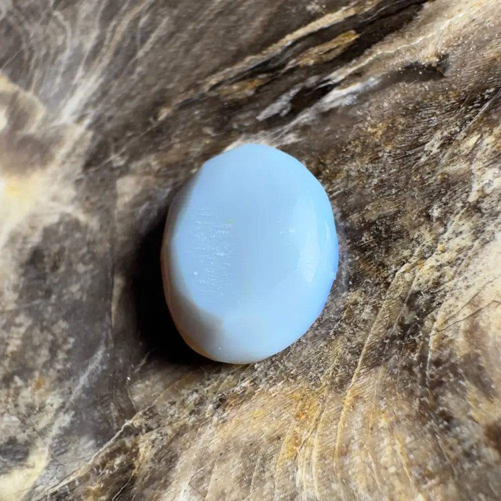 Smooth, light blue opal cabochon.
