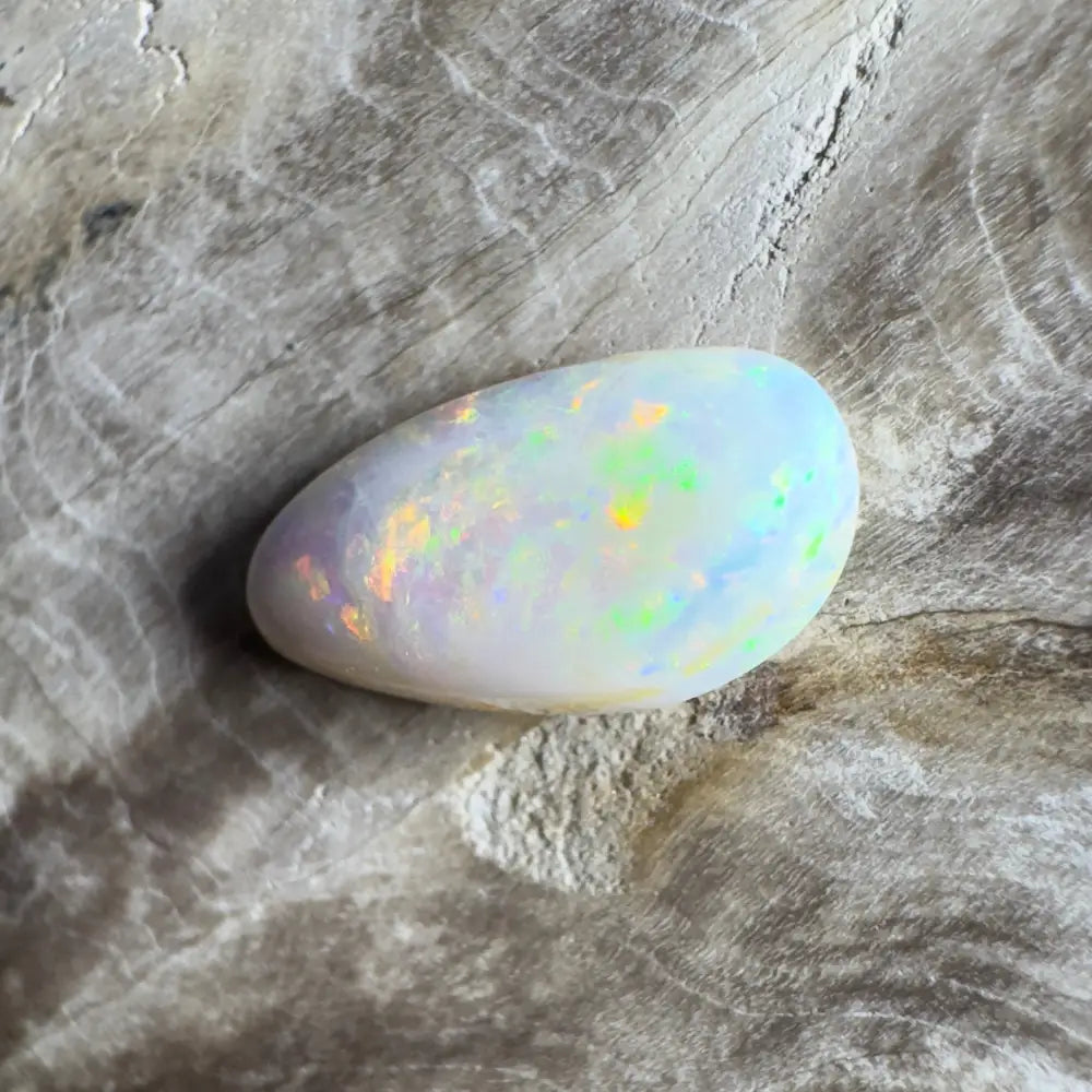 Iridescent white opal cabochon.