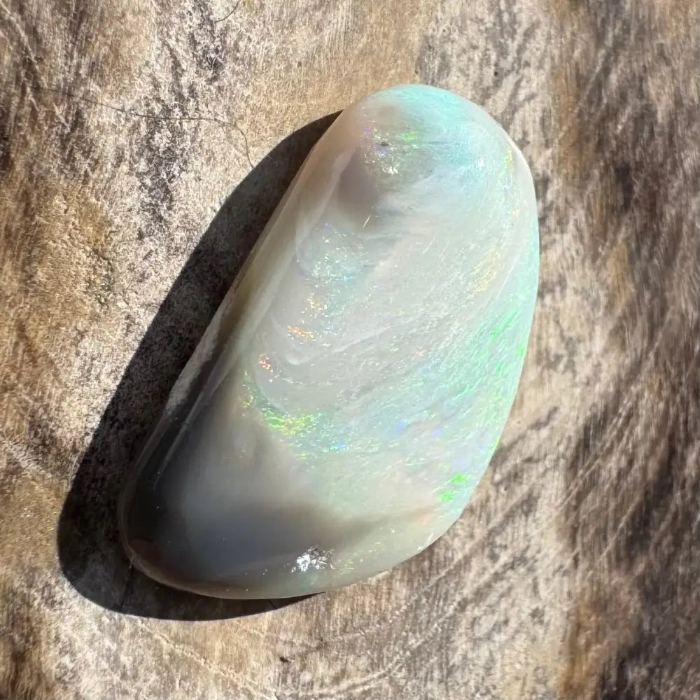 Iridescent white opal cabochon.