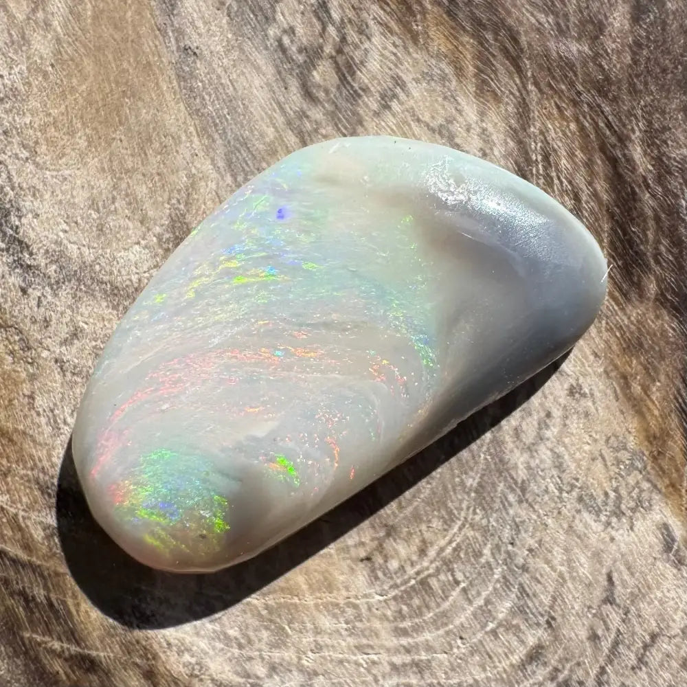 Iridescent white opal cabochon.