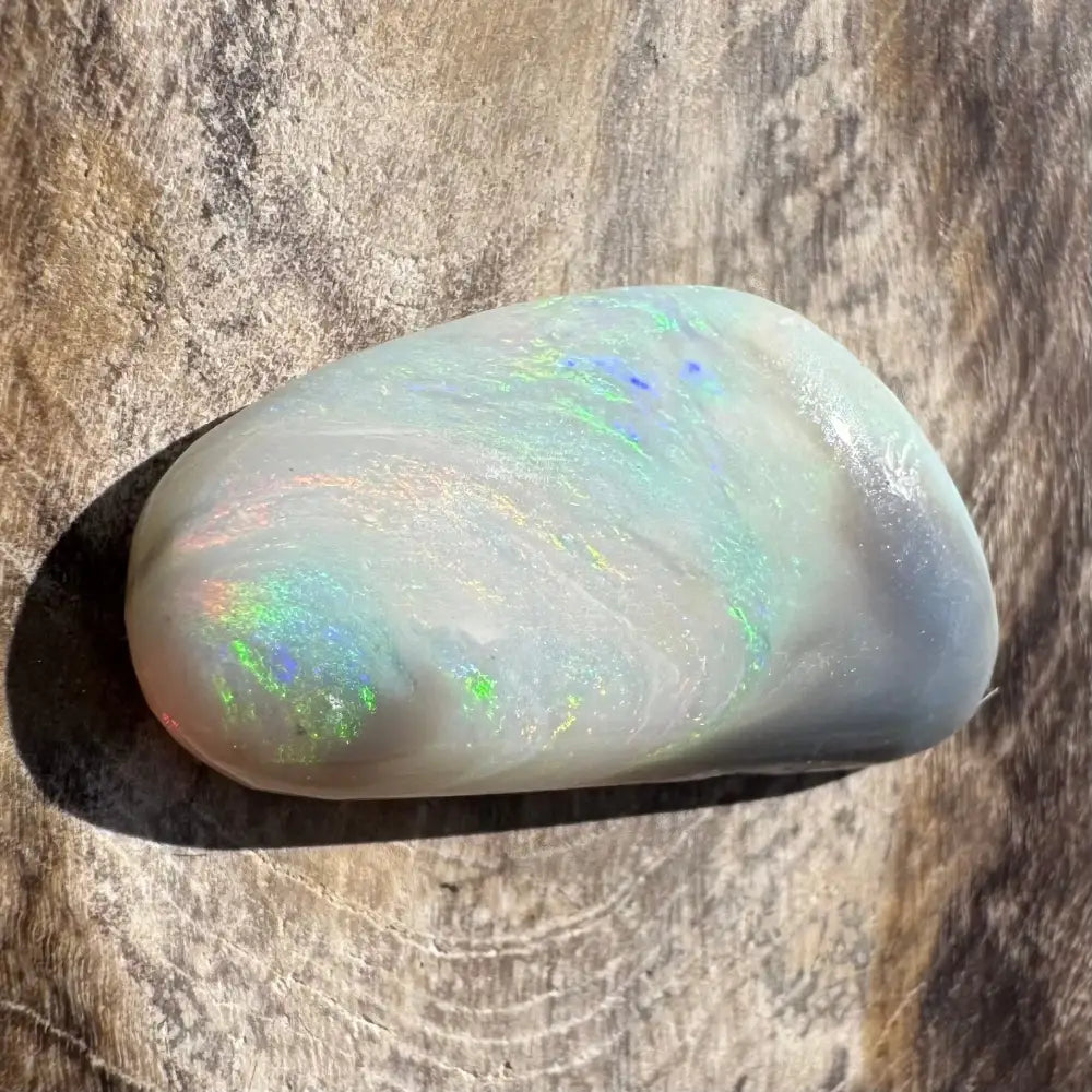 Polished opal with iridescent play-of-color.