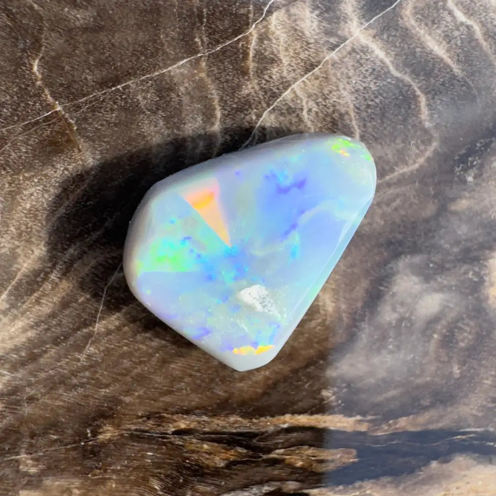 Polished opal gemstone with iridescent colors.