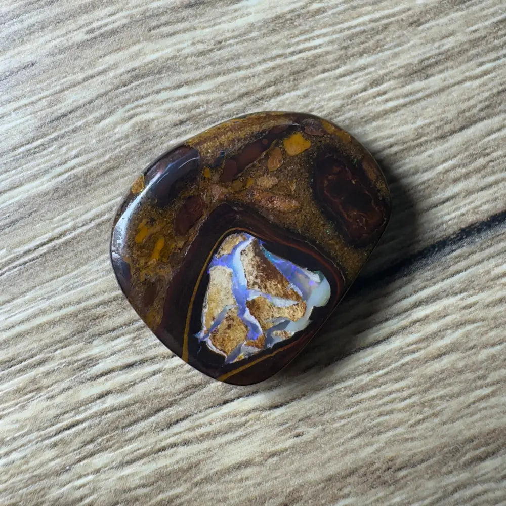 Polished Boulder Opal cabochon from Queensland showcasing vibrant play of color