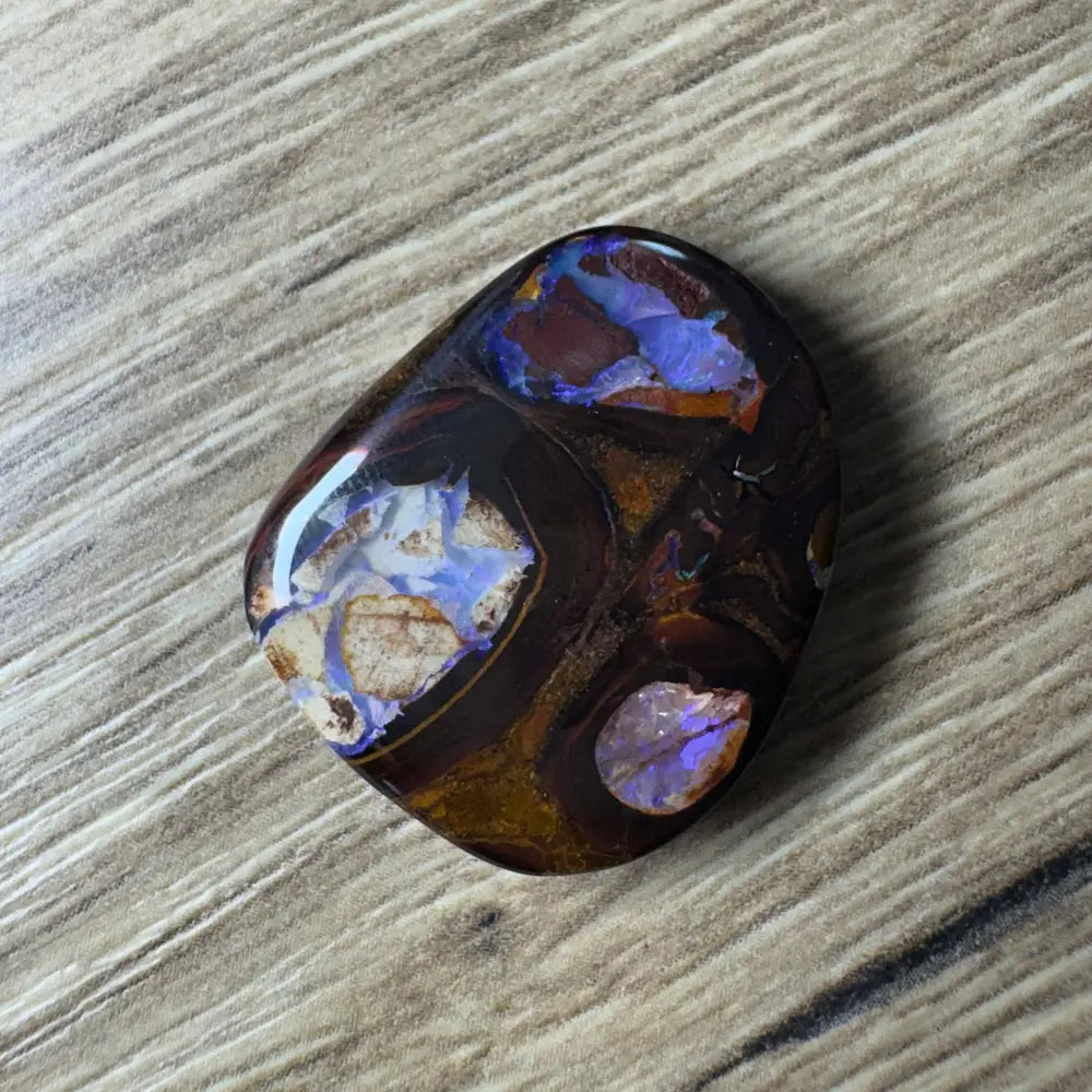 Polished 21.9 carat Queensland boulder opal with vivid blue and brown inclusions