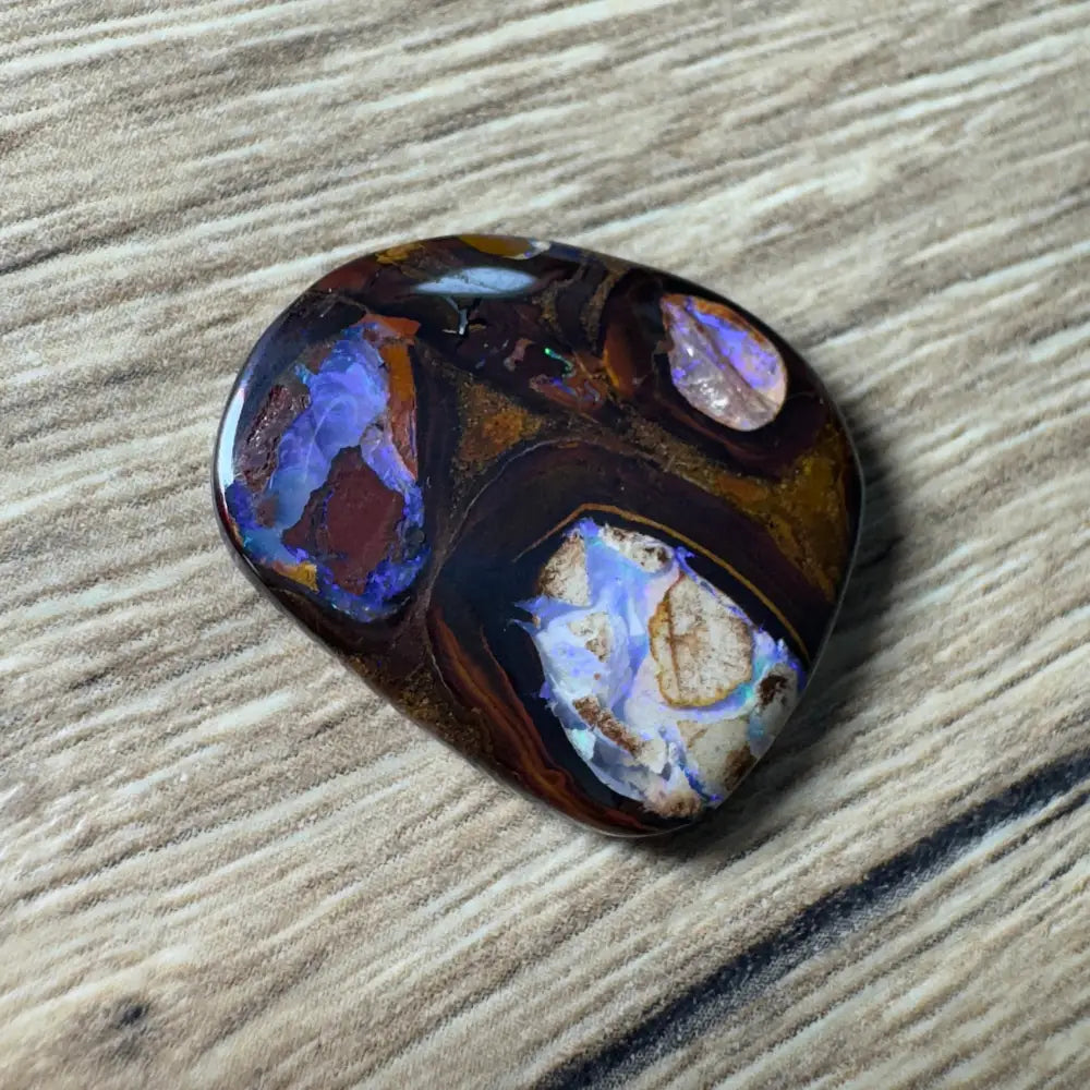 Polished Boulder Opal with vibrant color play from Queensland in the 21.9ct hand-cut boulder opal with pipes