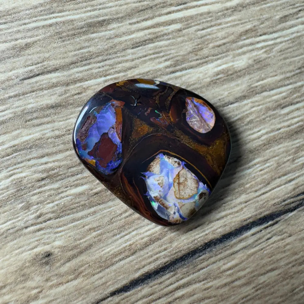 Polished boulder opal with vibrant color play displayed in 21.9ct Hand-cut Queensland Boulder Opal with Pipes