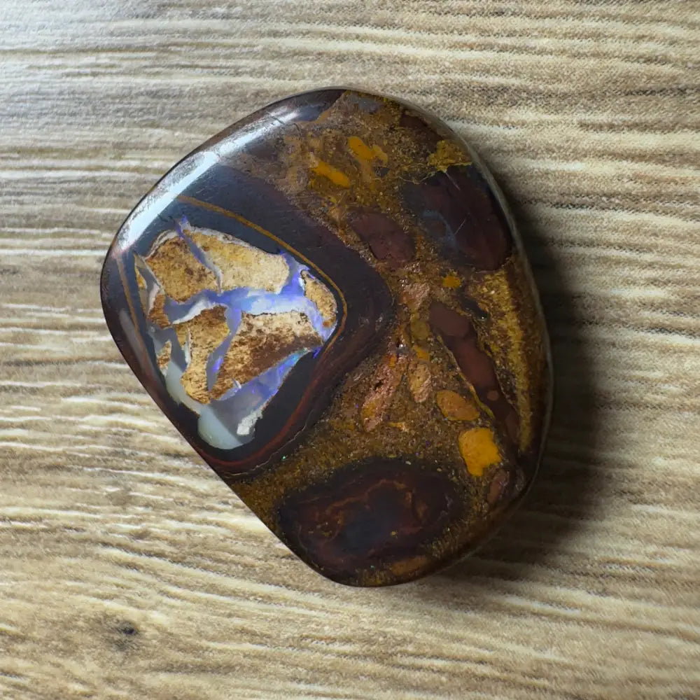 Polished Boulder Opal displaying vibrant blue and gold inclusions in a 21.9ct hand-cut Queensland specimen
