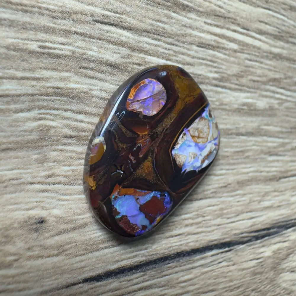 Polished 21.9ct Queensland Boulder Opal with vibrant color play and natural pipe formations