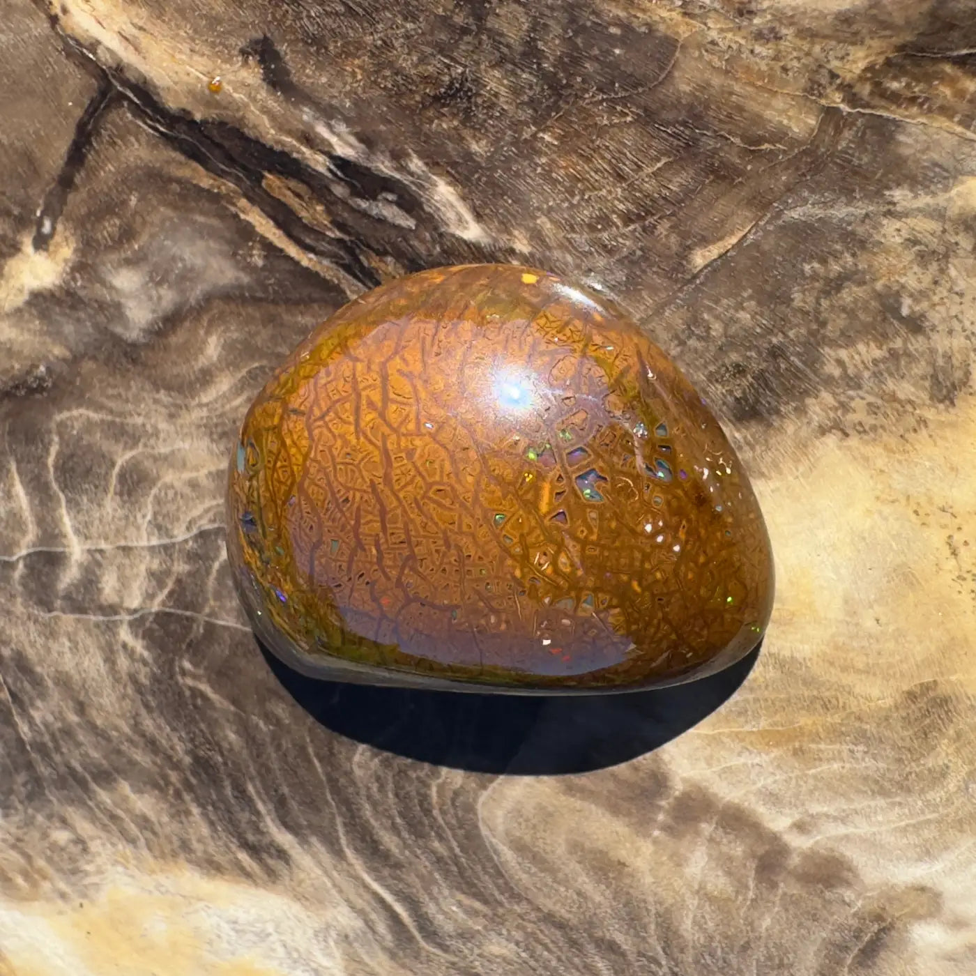 Polished brown opal with crackled pattern in a 24.6ct Hand-Cut Solid Boulder Opal jewel