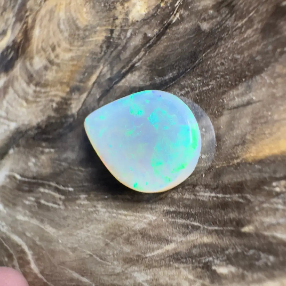 Teardrop-shaped opal with green and blue play-of-color.