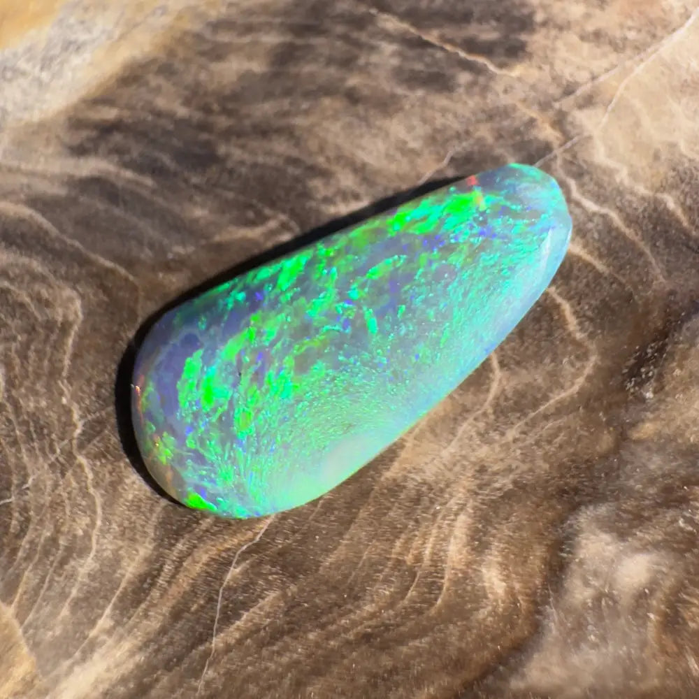 Iridescent green opal cabochon.