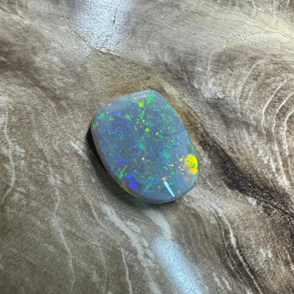 Iridescent opal gemstone in a 3.2 carat hand-cut Solid Lightning Ridge semi-black opal