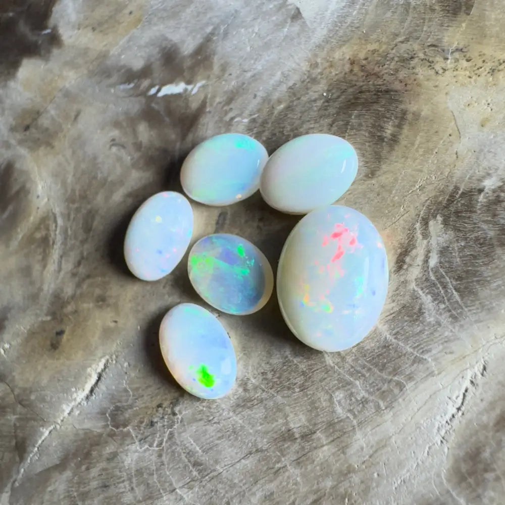 Six opalescent gemstones.