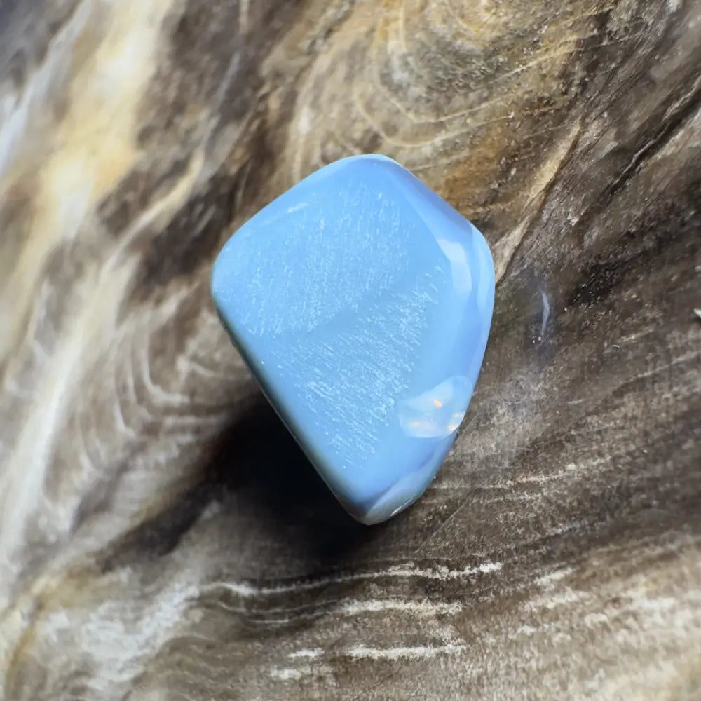 Polished, light blue gemstone.
