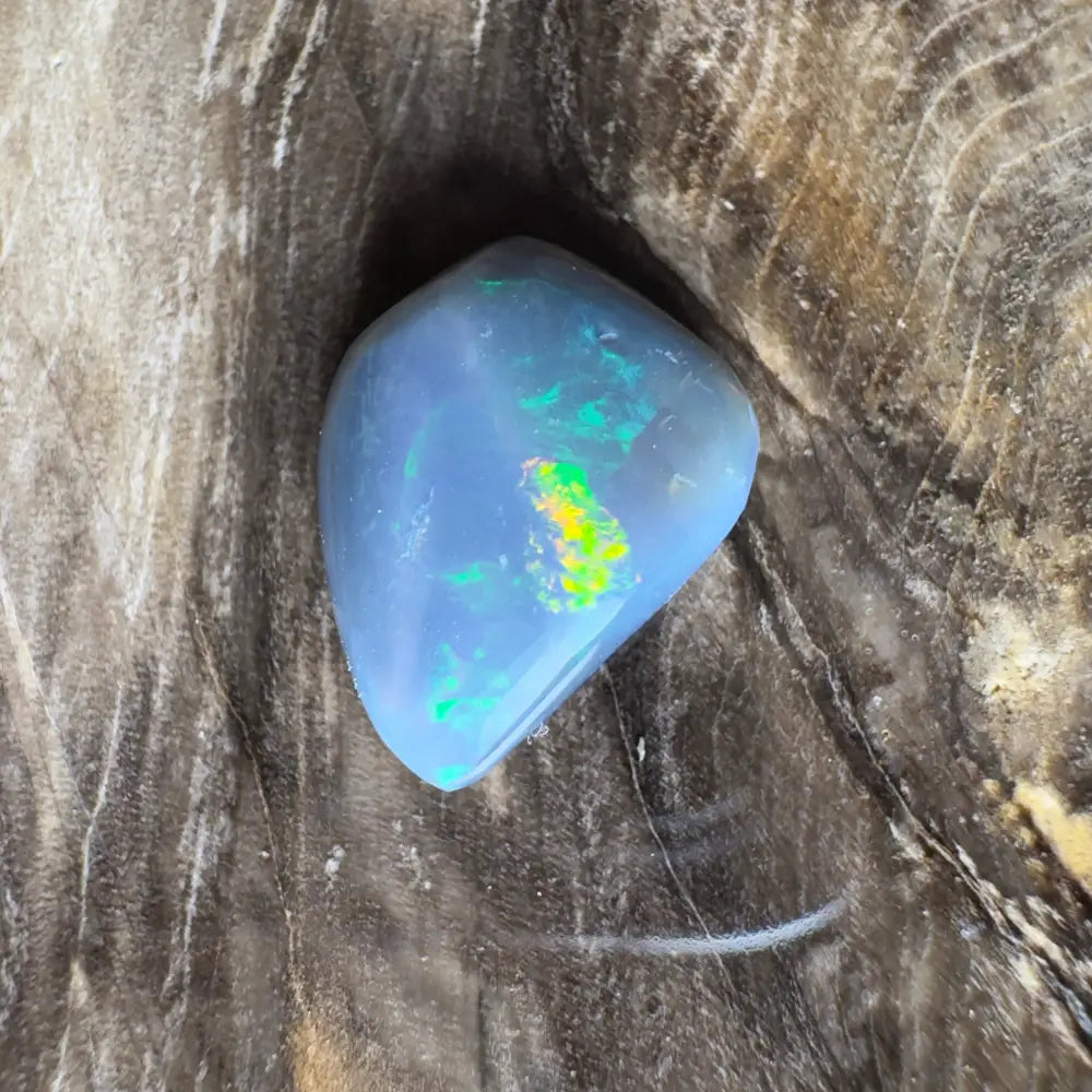 Polished blue opal with iridescent flashes.