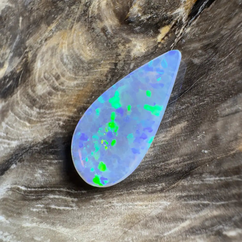 Teardrop-shaped opal with blue and green flashes.